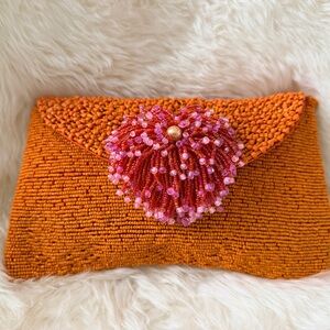 Handmade orange beaded clutch